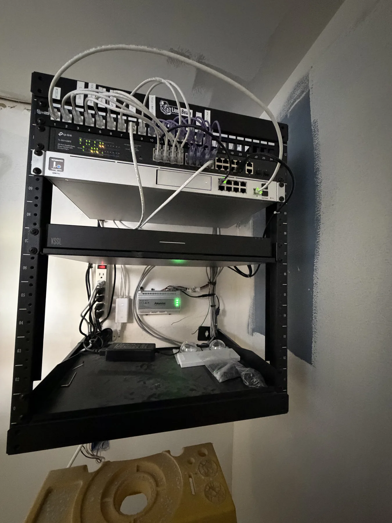 Wall-mounted open-frame network rack in a closet