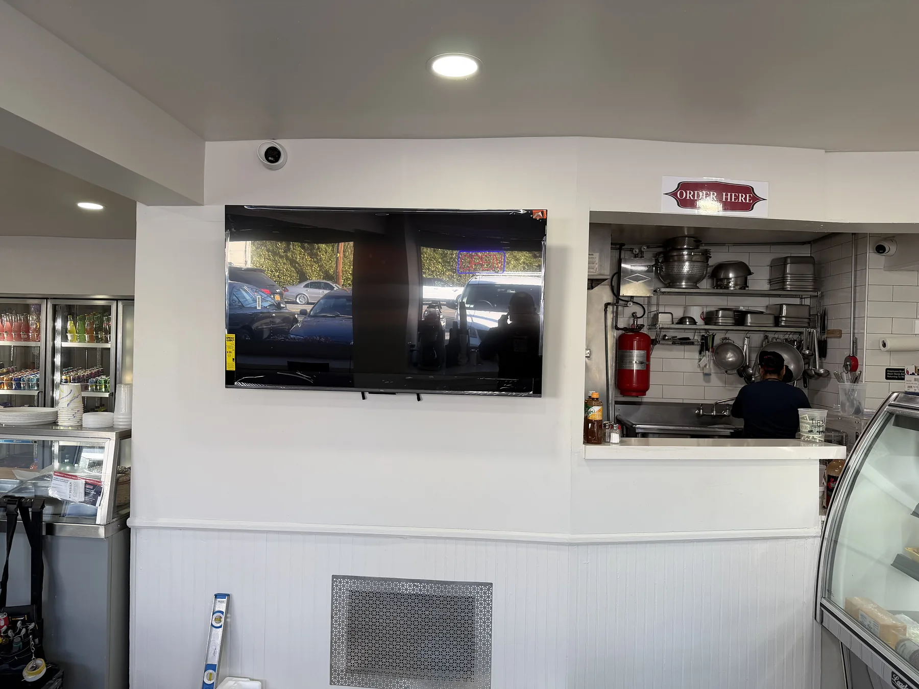 Wall-mounted commercial display above a cafe counter