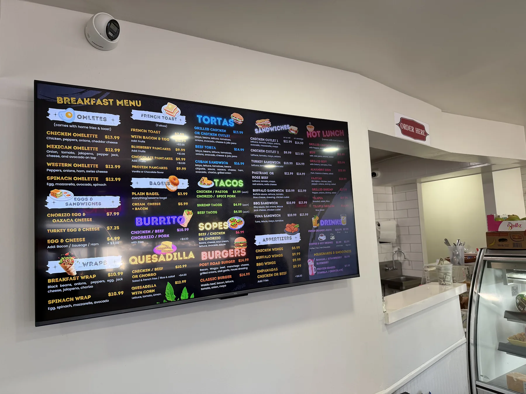 Digital menu board display mounted in a restaurant