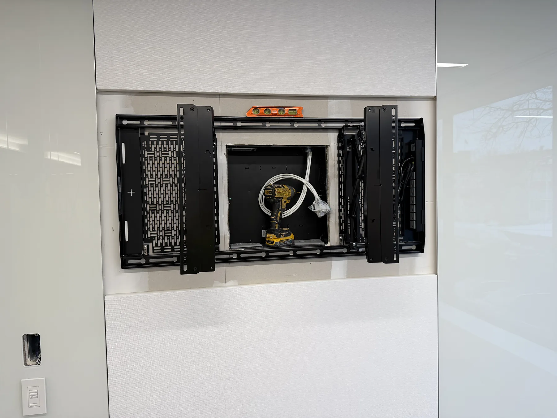 Heavy-duty dual-arm display mount installed on a white wall
