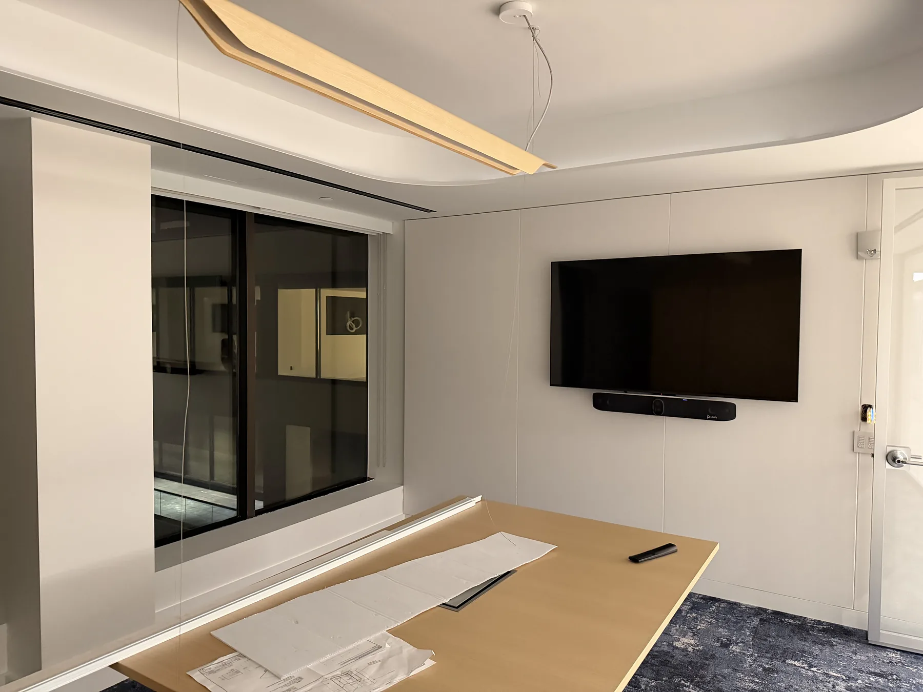 Conference room display and soundbar with nighttime window view