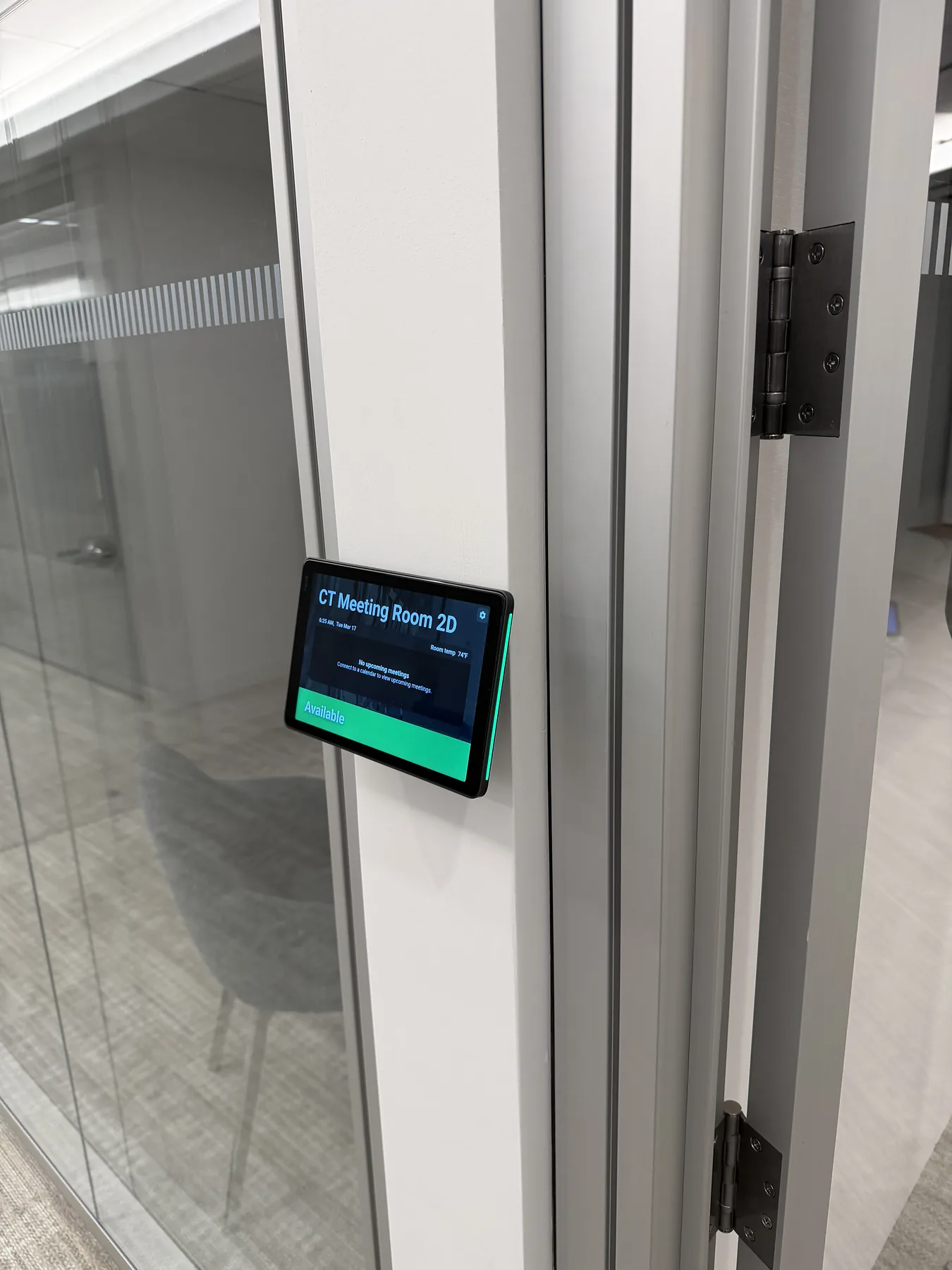 Meeting room scheduler mounted on a glass partition