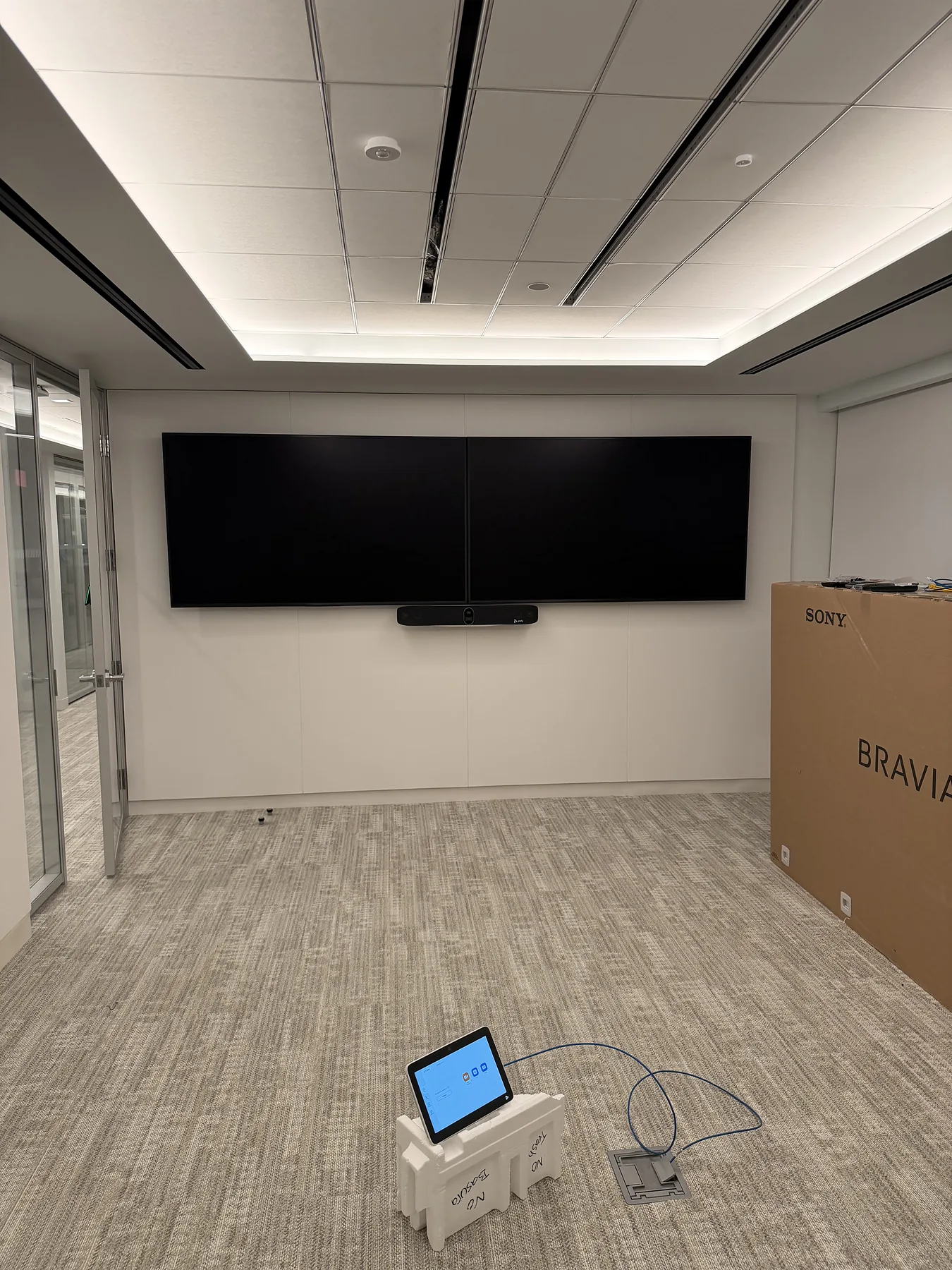 Dual conference displays with floor-standing control tablet under test