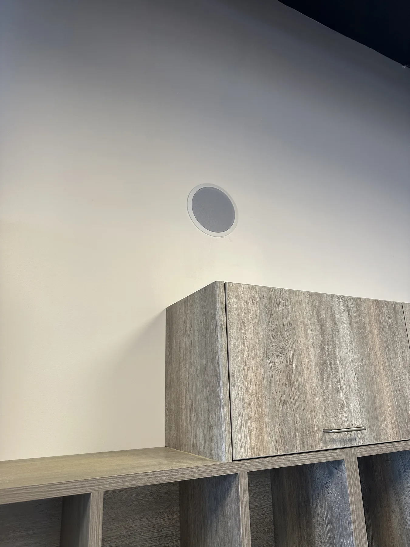 Grey wood-grain custom cabinetry or shelving install