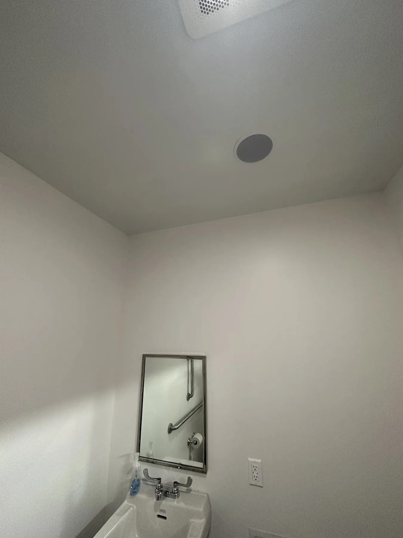 Flush-mount in-ceiling speaker installed in a restroom