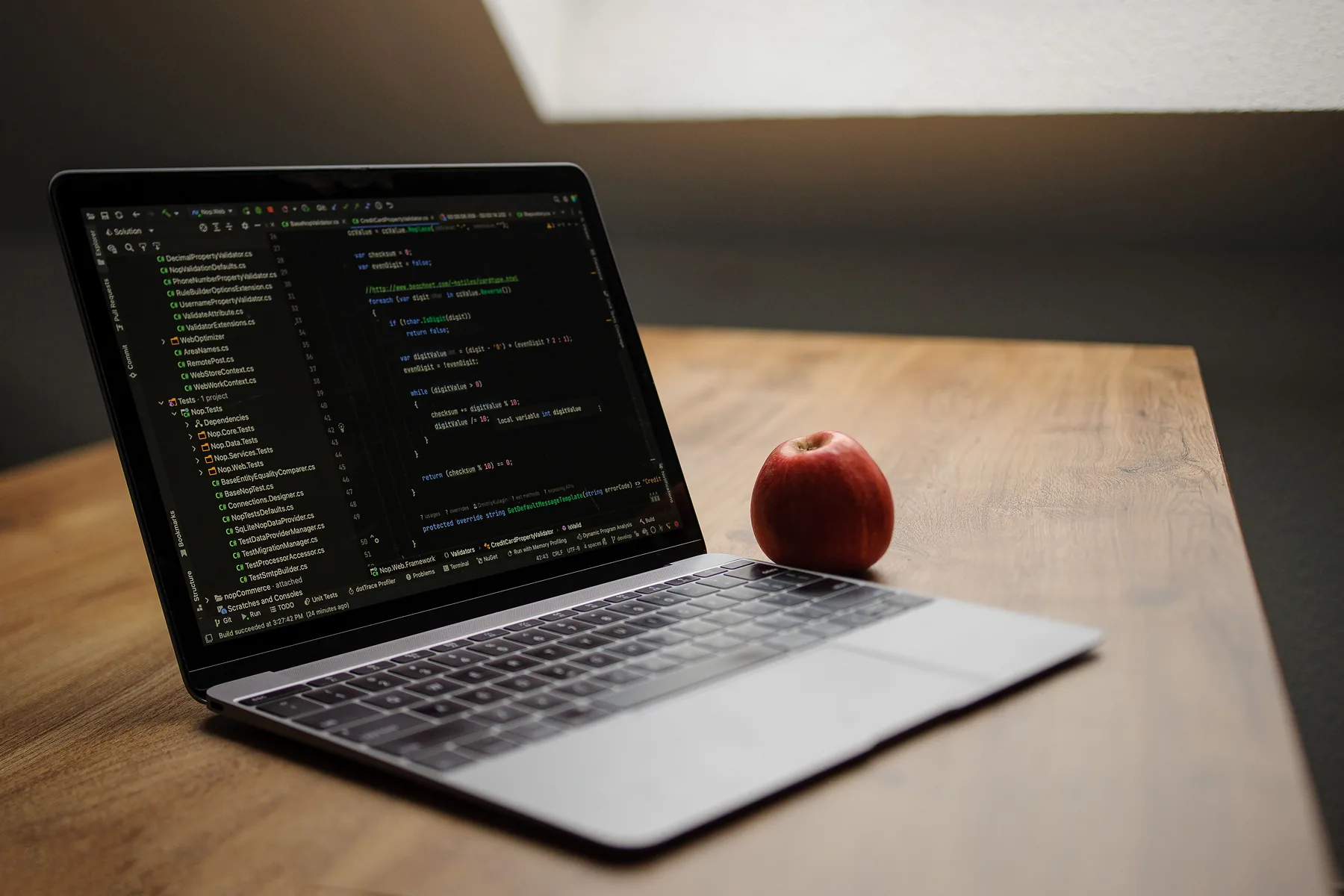 Laptop on a desk showing lines of code