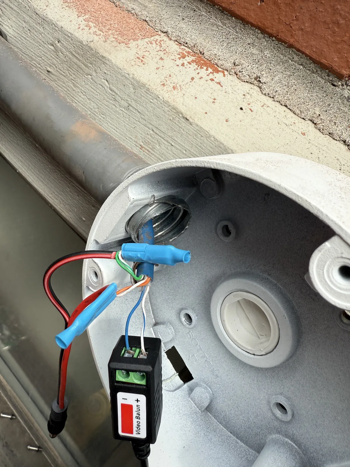 Camera base with wiring exposed