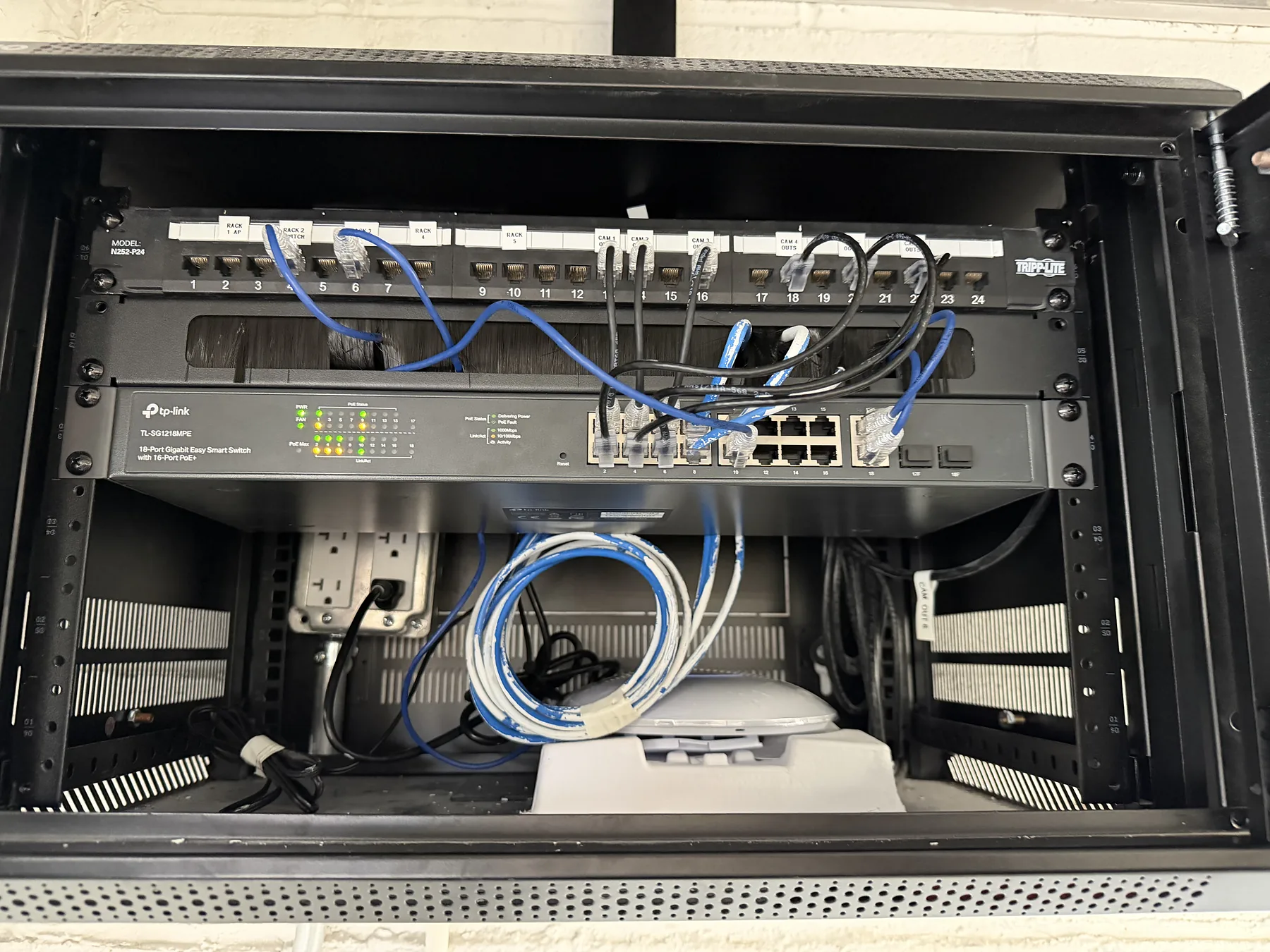 Rack-mounted network switch with blue Ethernet patch cables