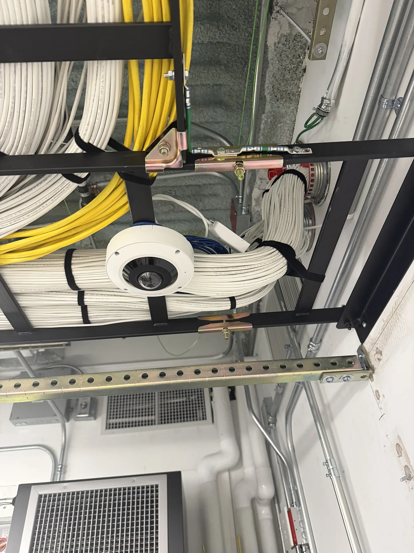 Ceiling cable bundles, conduit, and mounted circular sensor