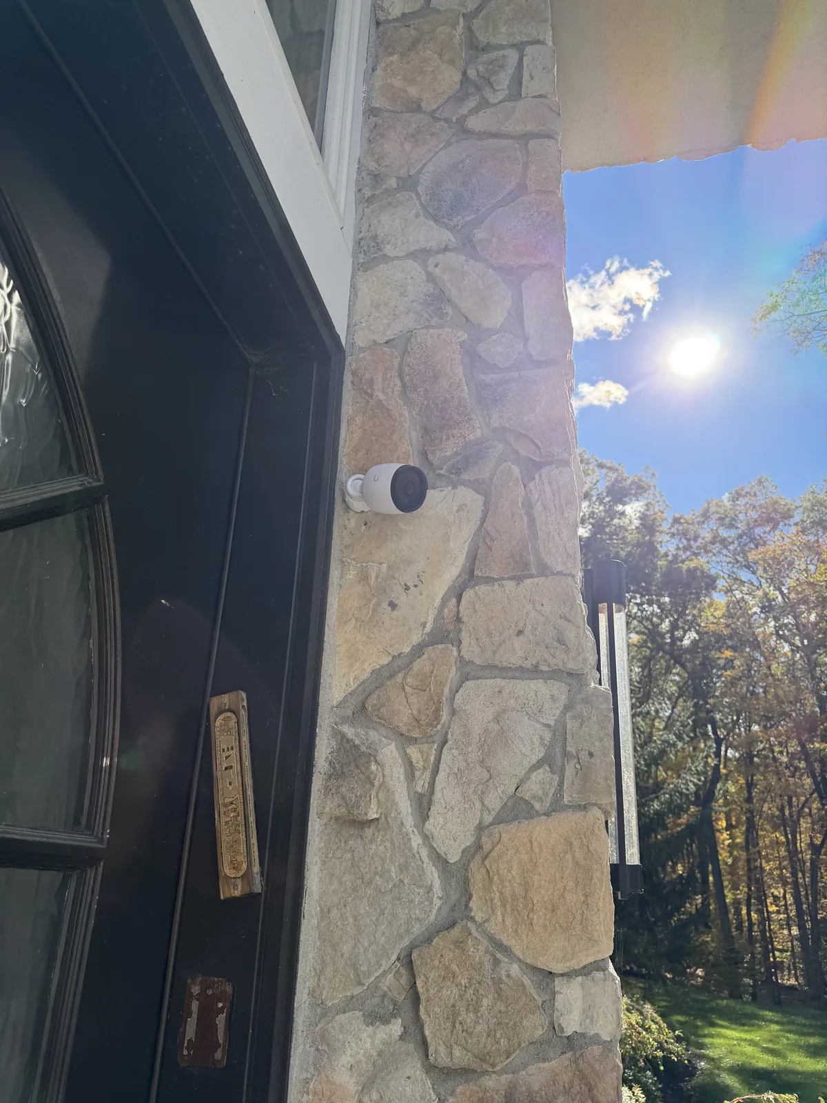 Security camera on a stone wall