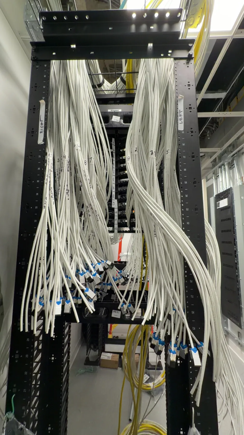 Organized vertical cable waterfall into network patch panels