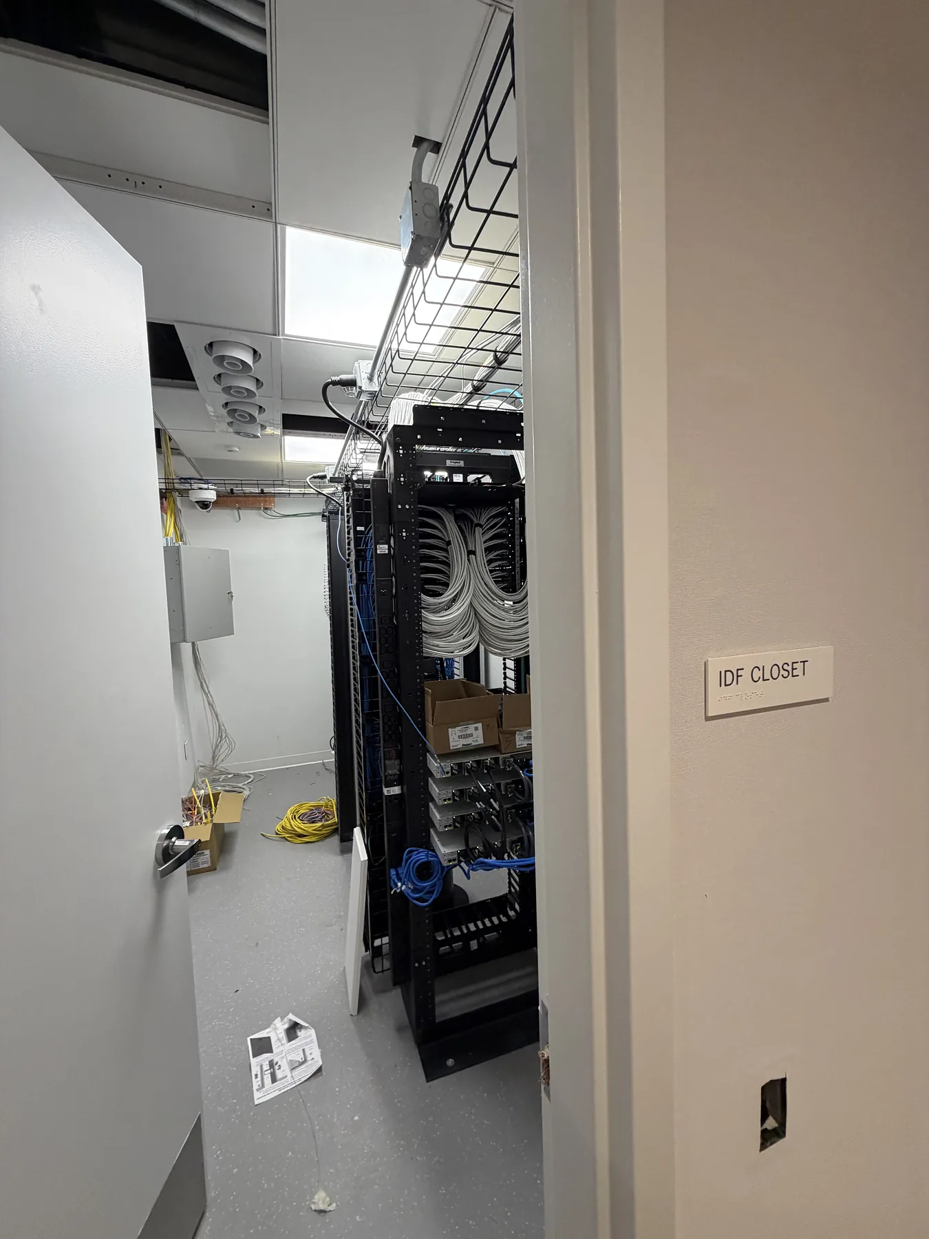 Network rack with equipment and cabling in a tech closet