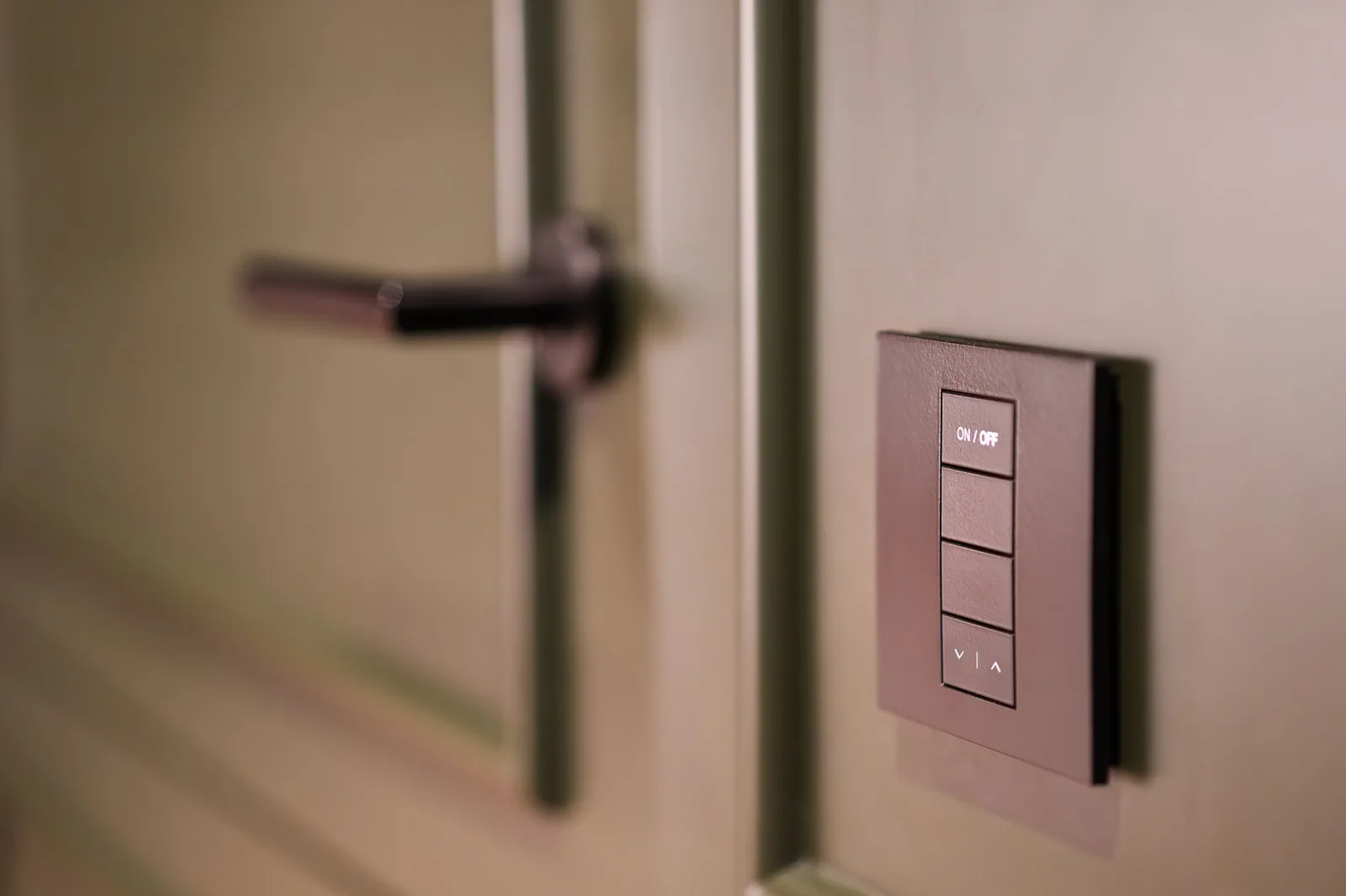 Keypad light switch beside a door