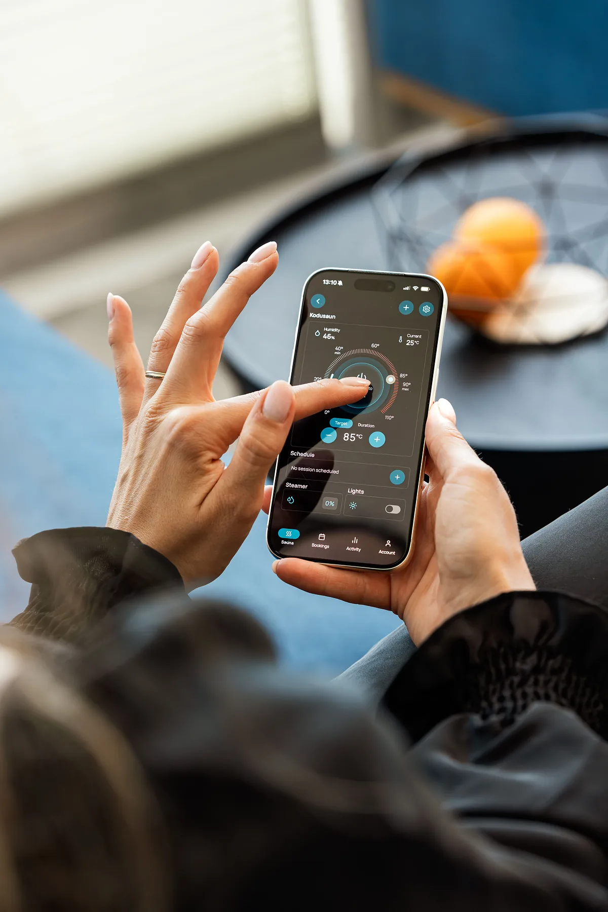 Hands adjusting smart home controls on a smartphone