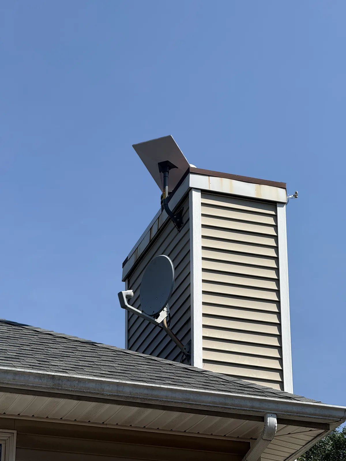 Starlink dish beside a chimney
